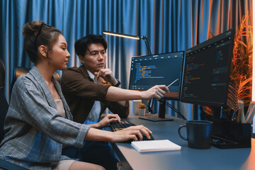 IT developers discussing with point to intelligent website development coder system running data...