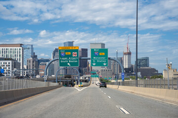 Road signs at an interstate highway for directions and arrows to Boston, New Haven and Springfield.