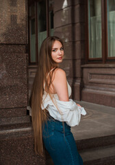 Fototapeta premium Youth concept. Nice beautiful Slavic beauty with long blonde hair, girl at city street, outdoor portrait