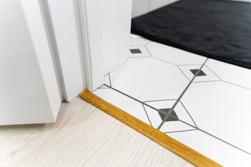 Experience a graceful and stylish transition that seamlessly blends both tiled and wooden flooring...