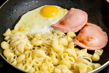 Egg Frying with Sausage and Pasta in a Pan