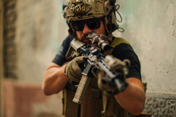 Air soft fighter with sniper rifle in action in crashed building.