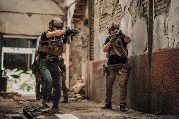 Group of air soft warriors shooting at opponent during action and mission