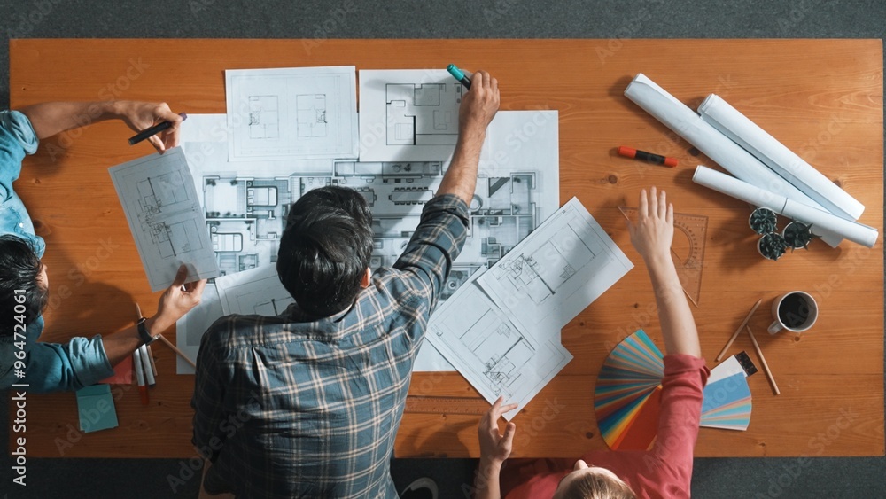 Poster group of people looking at blueprint while brainstorming idea. top view of engineer team looking and