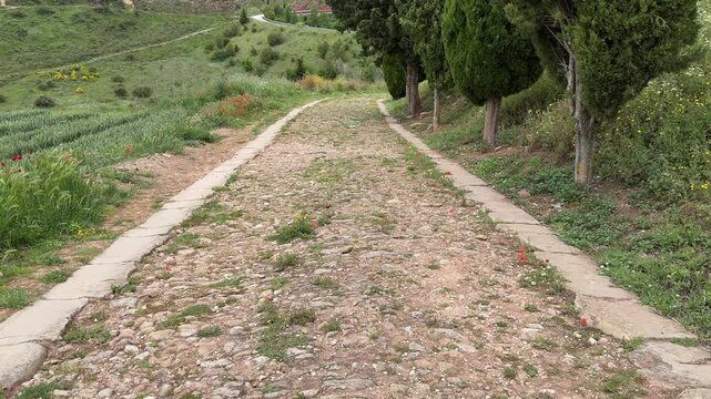 4K video of an old Roman Road leading away from the village of Cirauqui in Spain