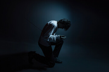A dramatic hero with a sword in his hands, suffering from defeat and injury, a portrait in the...