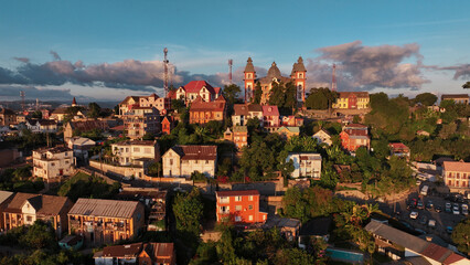 Aerial view of Antananarivo at sunset showcasing vibrant houses and lush greenery in Madagascar’s capital city