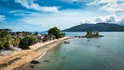 Aerial view of Nosy Komba Island showcasing the serene coastline and lush greenery of Madagascar under a clear sky