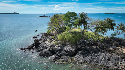 Aerial view of Nosy Komba Island in Madagascar showcasing rocky shoreline and lush greenery along the tranquil blue waters