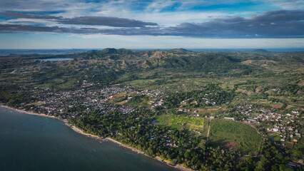 Fototapeta premium Aerial view of vibrant Nosy Be Island showcasing lush landscapes and coastal beauty of Madagascar near sunset