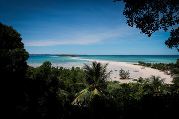 Tranquil view of Nosy Iranja Island in Madagascar with white sand beaches and clear blue waters under a bright sky