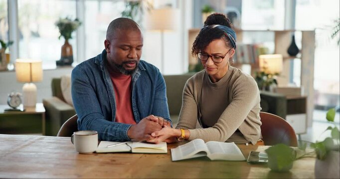 Worship, couple and bible by man and woman holding hands and praying for peace, religion or faith with coffee. Family, God and people with prayer, christianity or Jesus Christ praise together in home