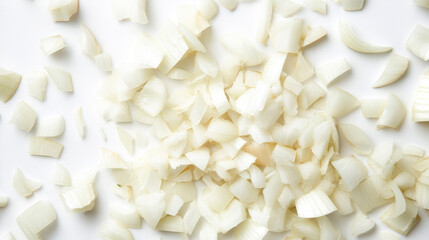 Close-up view of chopped onion pieces against a white backdrop. The image is taken from directly above.