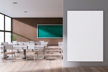 Modern stylish classroom interior with empty white mock up banner, panoramic window and city view, wooden floor and green blackboard on wall. School, university and education concept. 3D Rendering.