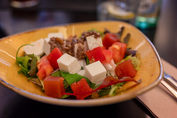 Summer salad with feta cheese and nut dressing