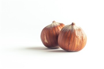 Onions sit side by side on a white surface, perfect for use in food or still life photography