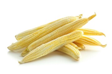 A pile of fresh corn on a clean white surface, ideal for food and still life photography