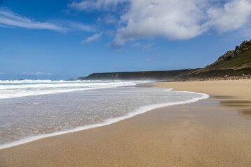 Looking along Sennen beach on the Cornish coast, on a sunny summer's day