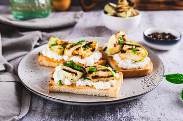 Sandwiches with ricotta, grilled zucchini and green onions on a plate
