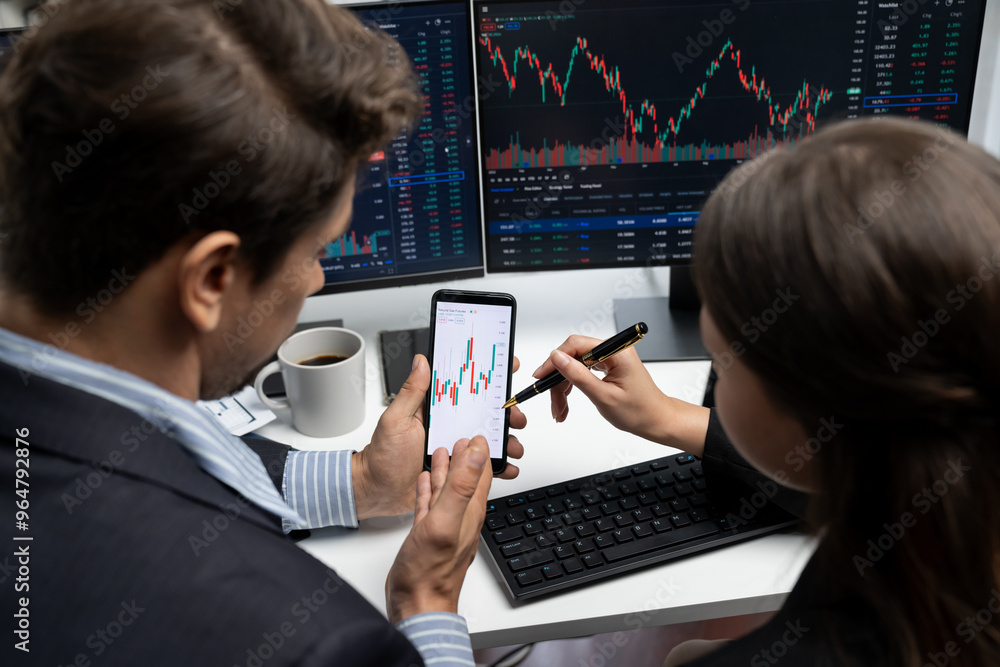 Aufkleber focusing on phone with discussing dynamic stock market in two business traders online website compar
