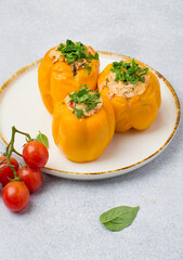 Stuffed yellow pepper. Sweet pepper with rice and minced meat on a light background.