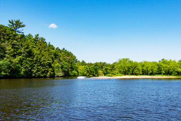 A fisherman fishes near one of many sandbars created from the sediment of the Cambrian Sandstone of...