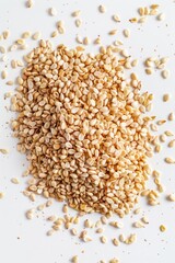 Fototapeta premium A compact pile of sesame seeds on a white surface