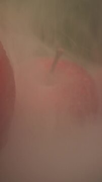 morning dew on top of fresh ripe red apples with smoke, concept of healthy eating compared with harmful activities