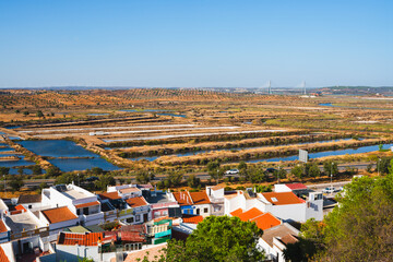 Charming Castro Marim, Portugal, with terracotta rooftops overlooking expansive salt marshes.