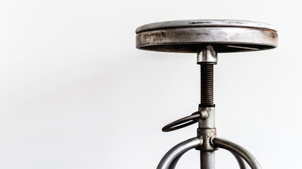 Industrial metal stool with round seat and adjustable height mechanism. Weathered finish highlights vintage look and robust construction