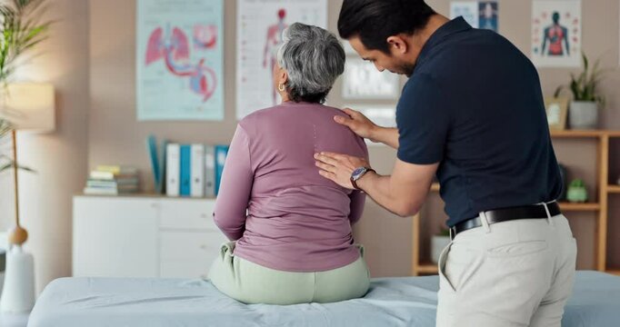 Physio, back pain and senior patient in clinic, consultation exam and medical support for scoliosis. Man, chiropractor and specialist for healing treatment, assessment and helping woman for arthritis