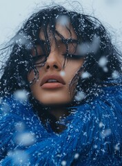 an Indian woman in blue fur is standing in a cold winter day, covered with snowflakes