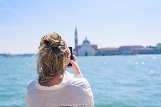 woman taking picture on the phone