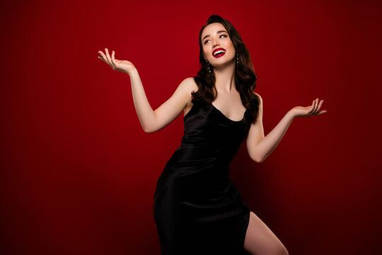 Stunning attractive lady model wearing black dress empty space promo isolated on red color background