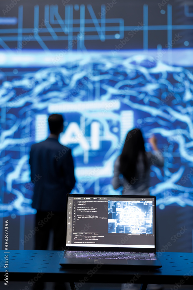 Poster focus on complex ai brain models being analyzed on laptop by developers in blurry background. close 