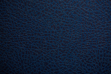 Dark blue textured leather background. Abstract leather texture.