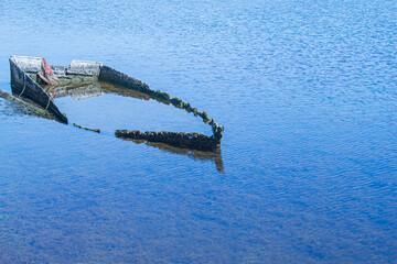Abandoned and sunken boat in the sea. Ship sunk in the cemetery of abandoned ships in the Delta del...