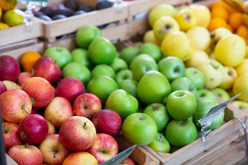 Many of fresh ripe apples on the market, puts out for sale. Close-up image
