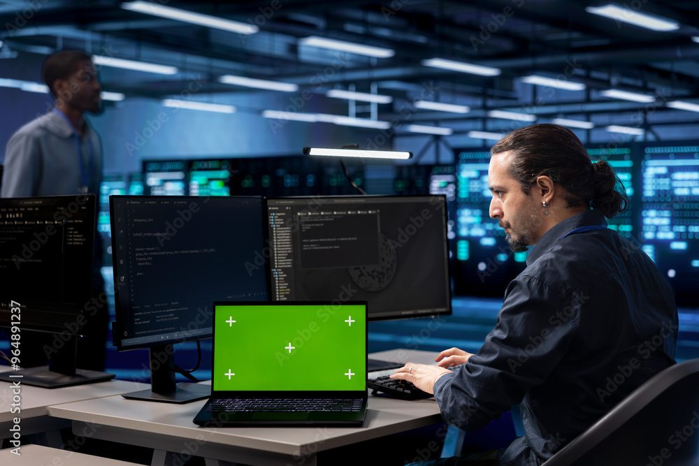 Poster admin in data center using system monitoring software on isolated screen laptop to identify root cau