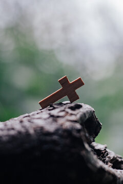 Wooden rosary with cross - with bokeh in background