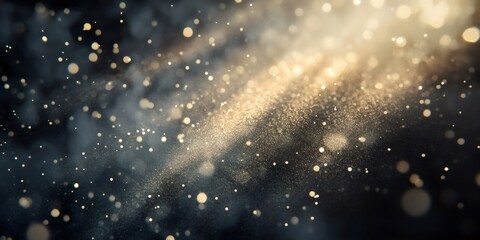 Obraz premium Abstract background with out-of-focus golden light bokeh and a dark grey background.