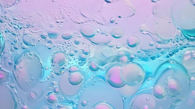 Foaming soap and bubbles of washing cleanser close up. Hyaluronic acid liquid makeup remover micellar water facial skin care. Powder foam close up background. Transparent cleaner. Abstract blue, pink.