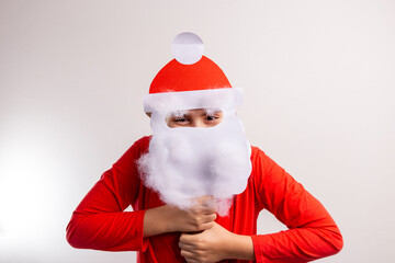 a boy wearing a paper craft santa hat and beard, disguise New Year mask, DIY, ideas for winter kids activity, recycled paper