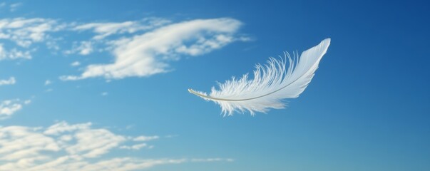 White feather floating in blue sky, tranquility and freedom concept