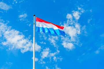 The flag of Luxembourg features a horizontal tricolor of red, white, and light blue. It is one of the few flags that do not use the colors red, white, and blue in that order. Adopted on June 23, 1972.