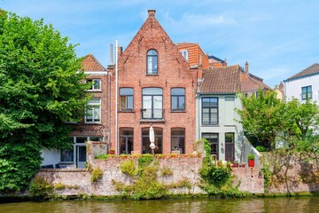 The canal in Ghent, Belgium, is a beautiful place to take a stroll and admire the old houses. This house has a garden on the waterside, making it a perfect spot to relax and enjoy the scenery.