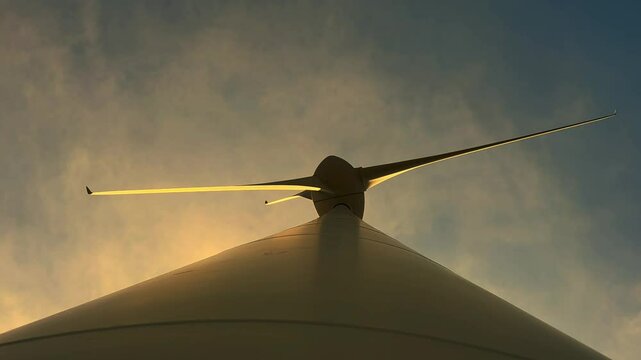 Directly Below Against Blue Sky and Clouds a Wind Turbine in Sunset at 2363 Meter in Andermatt, Uri, Switzerland, Europe