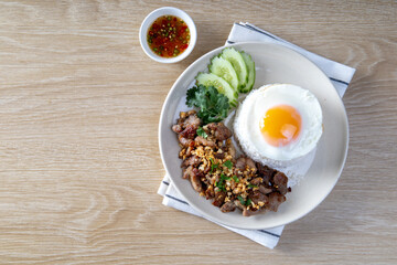 Rice topped with pork, garlic, pepper and fried egg