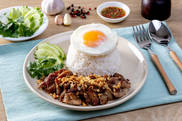 Rice topped with pork, garlic, pepper and fried egg