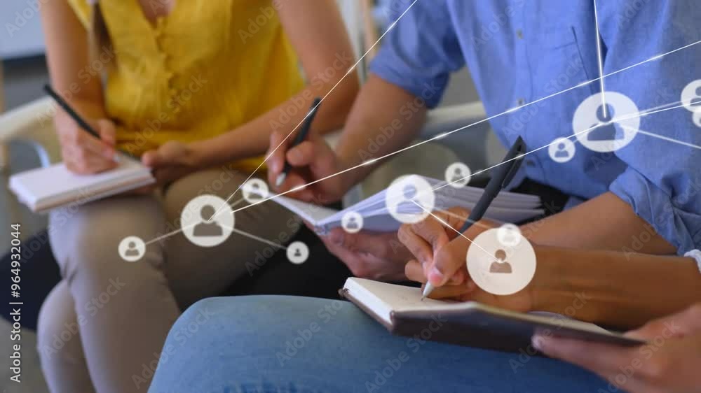 Poster animation of network of connections with icons over diverse colleagues taking notes in office